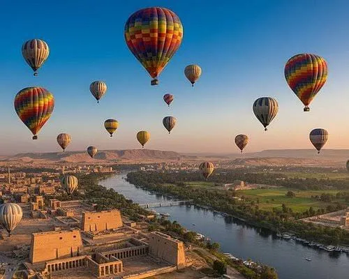Hot-air balloons drifting over the Nile valley and temples of Luxor at dawn