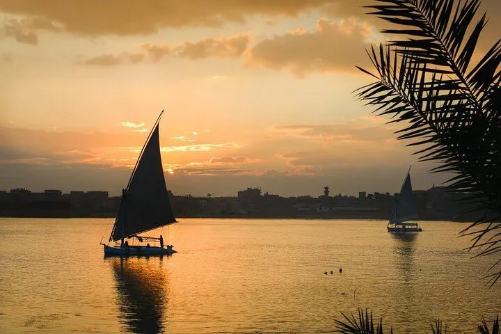 A felucca under sail on the Nile at golden sunset