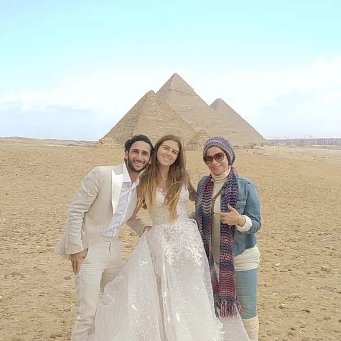 A newly-wed couple celebrating at the Pyramids of Giza