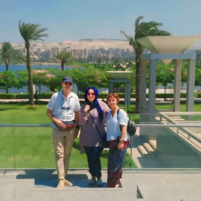 A family of guests in the riverside gardens beside the Nile