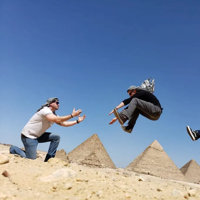 Guests jumping for joy above the Giza pyramid panorama