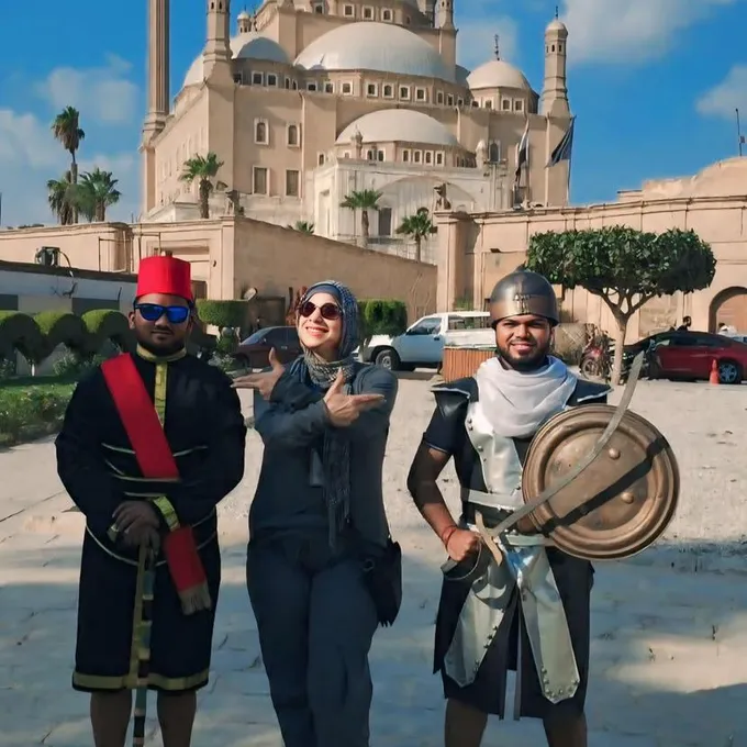 Guests with a traditional performer at the Mosque of Muhammad Ali