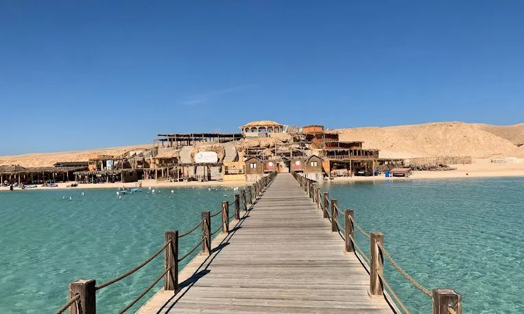 A jetty reaching over turquoise water to an island near Hurghada