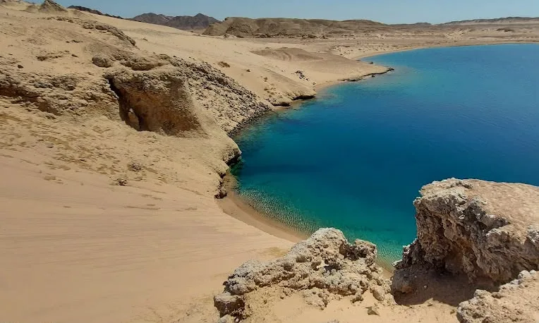 A turquoise lagoon meeting bare desert headlands at Ras Mohammed, Red Sea