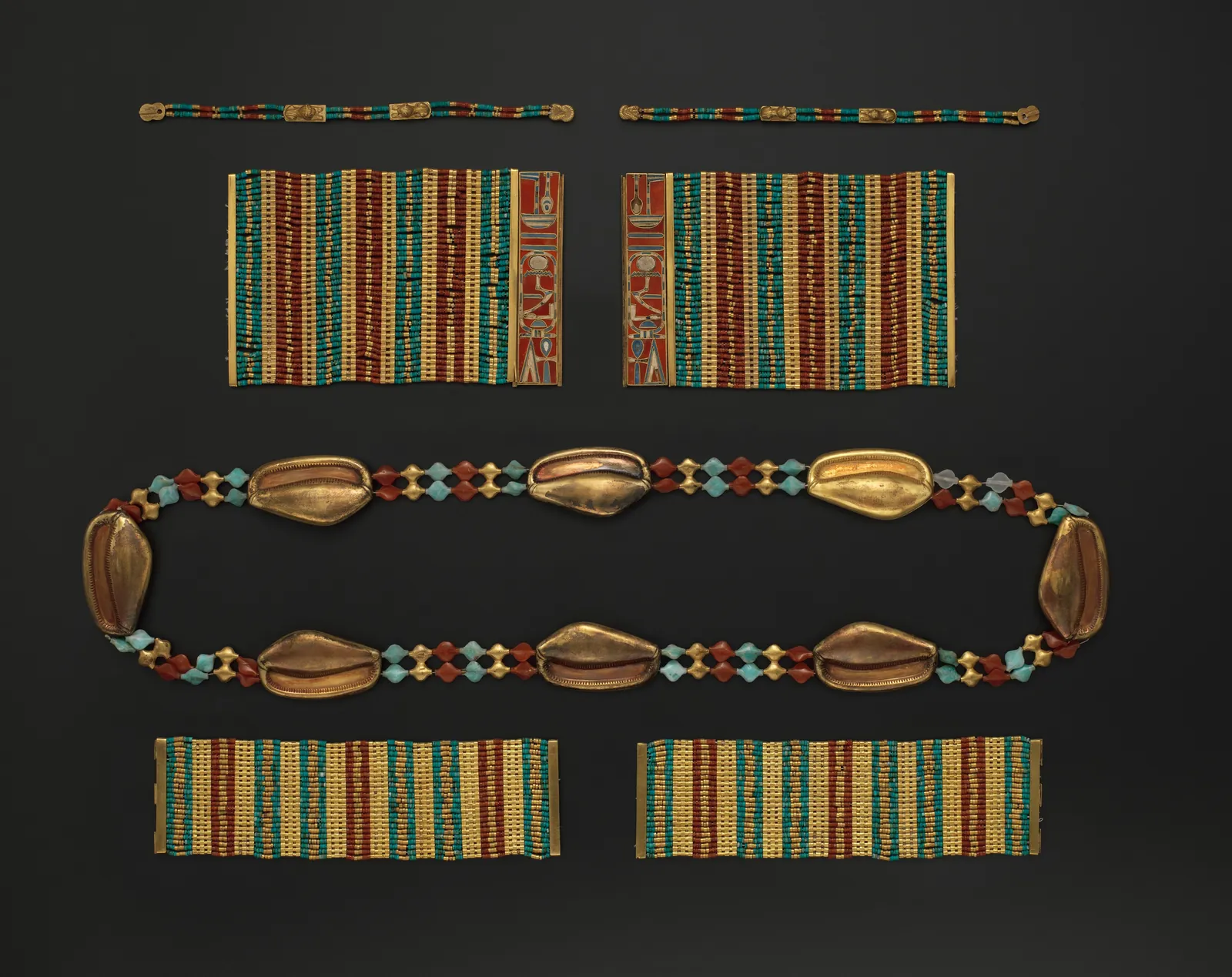 A gold cowrie-shell girdle and bracelets strung with carnelian, turquoise and lapis lazuli, from the reign of Amenemhat III