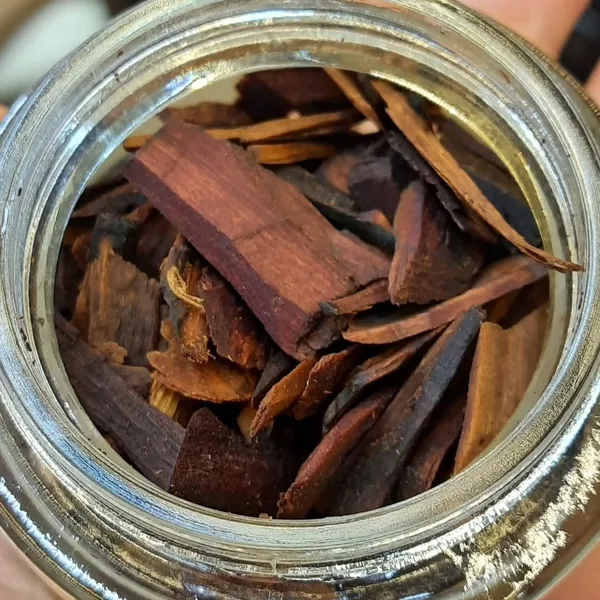 Chips of sandalwood in an open glass jar