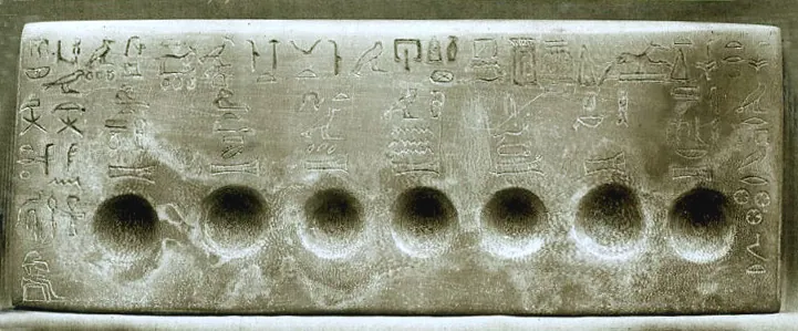 An Old Kingdom offering slab with a row of hollows for the seven sacred oils