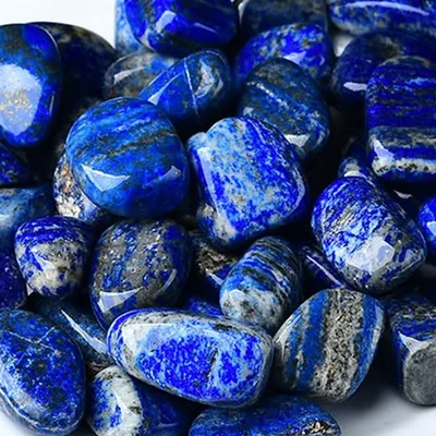 Polished lapis lazuli stones, deep blue flecked with gold
