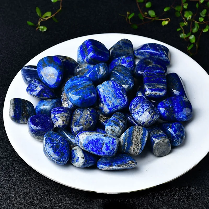 Polished lapis lazuli stones on a white plate