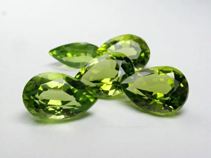 Five pear-cut peridots