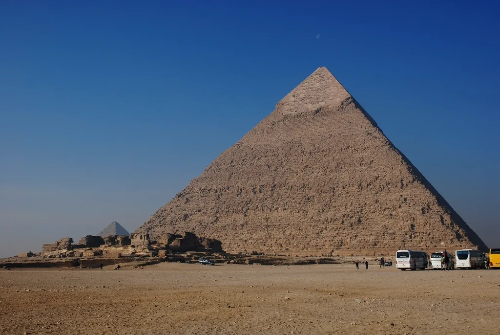 The Pyramid of Khafre at Giza under a clear blue sky, the Pyramid of Menkaure beyond