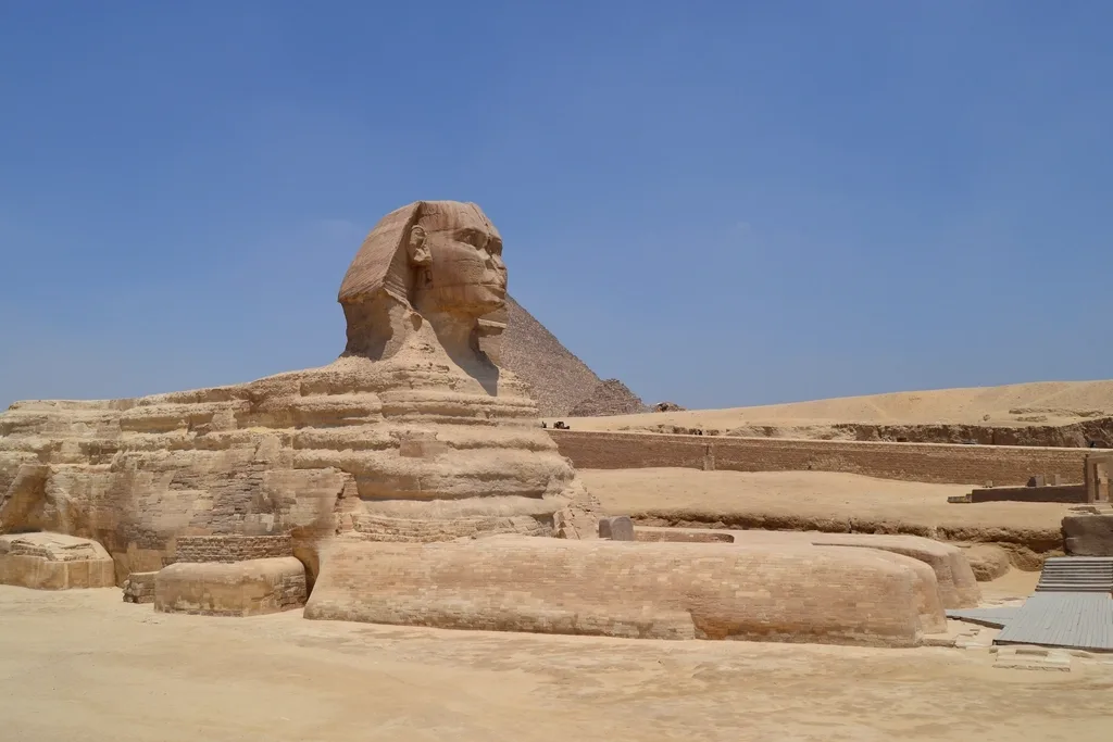 The Great Sphinx of Giza with a pyramid rising behind it